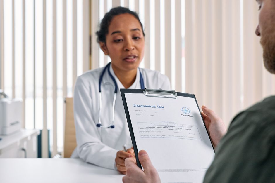 Family doctor reviewing health screening results with patient