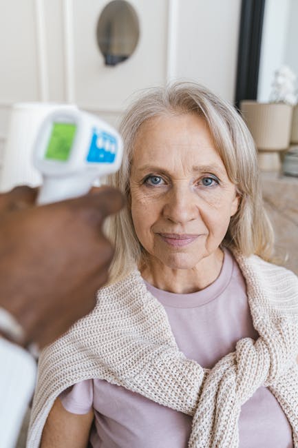 Elderly person measuring blood pressure at home, considering doctor guidance